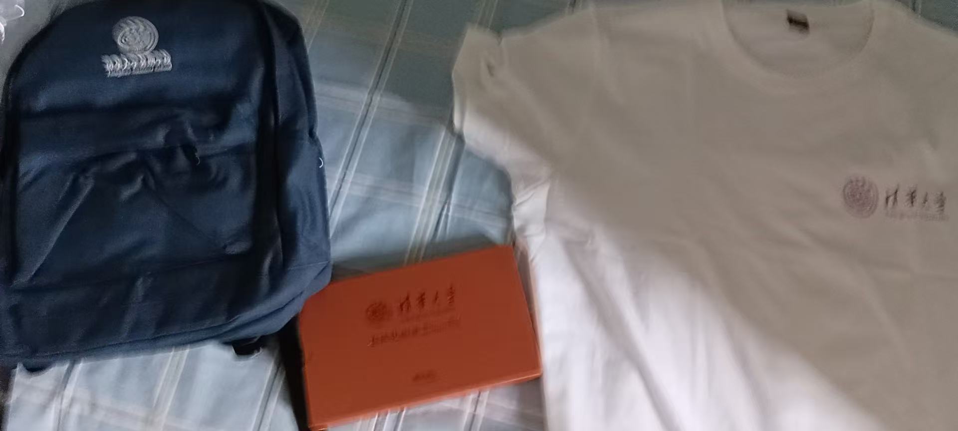 The backpack, T-shirt, and handbook handed out at the summer camp